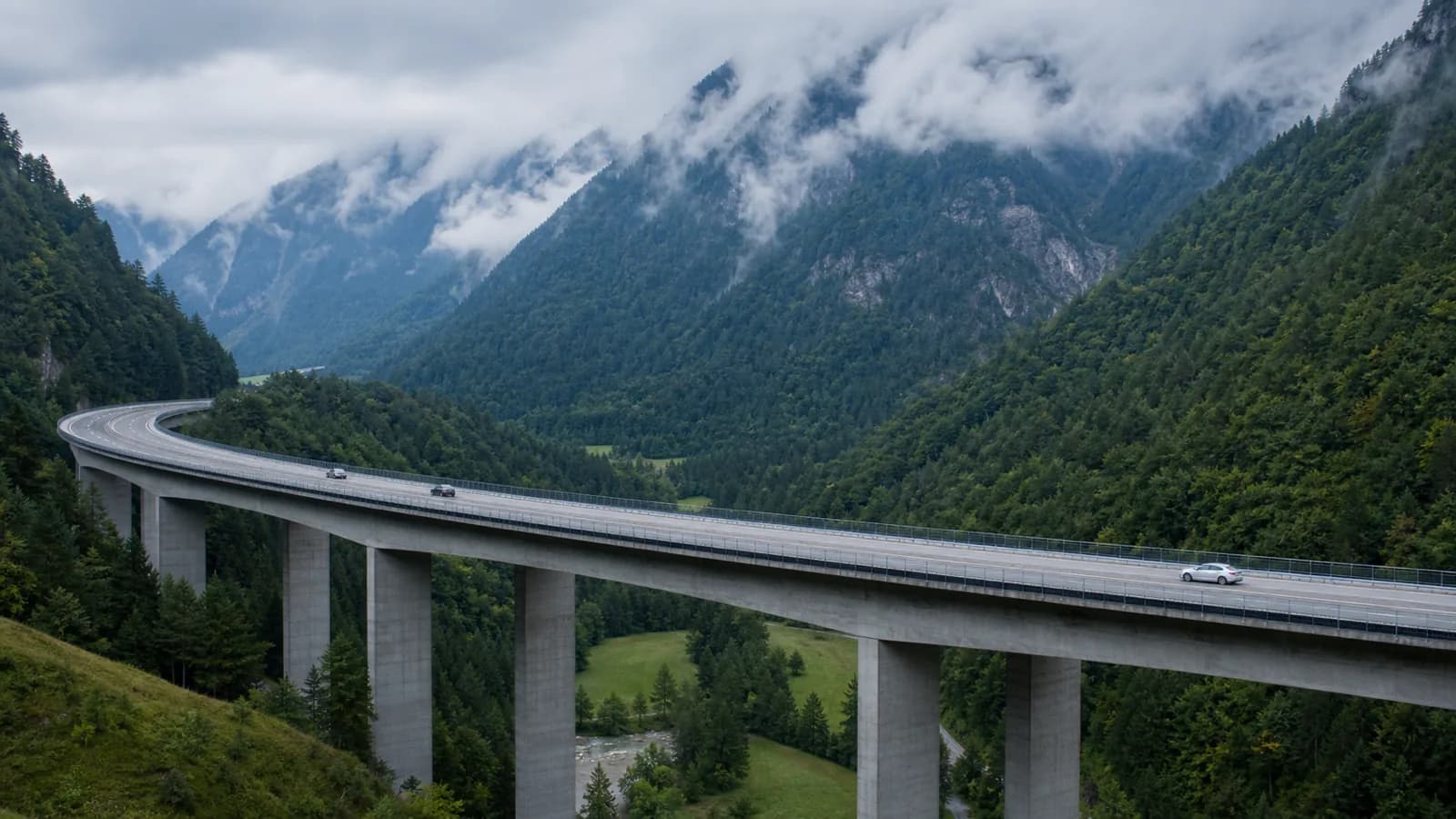 Wiadukt austriackiej autostrady alpejskiej między zalesionymi zboczami